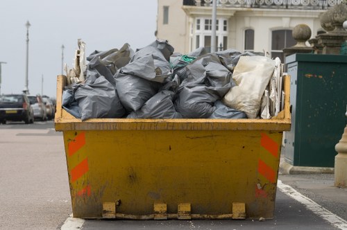 Construction site with builders waste being cleared in Teddington